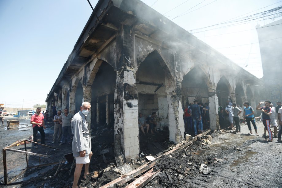 People gather at the site of a suicide attack at the entrance of the Shi'ite Mausoleum of Sayid Mohammed bin Ali al-Hadi in Balad, north of Baghdad, Iraq, July 8, 2016.