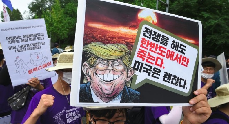 South Korean protesters hold placards at an anti-Trump rally