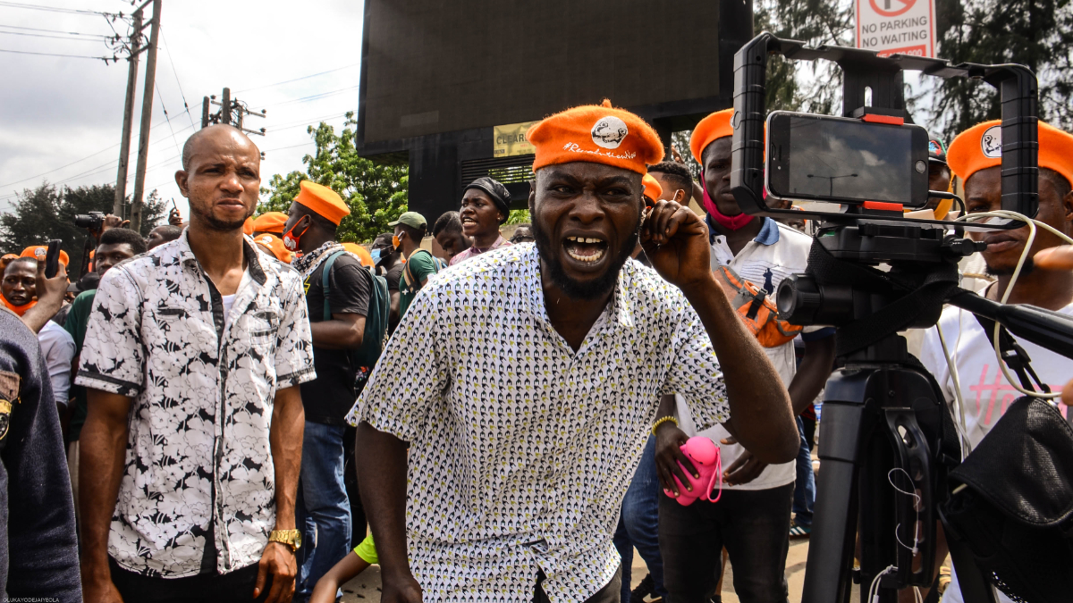 A Member of the Revolution Now protesters reacts to a live streaming phone in Lagos Nigeria while demanding for better governance for the present administration, during a protest in Lagos Nigeria to mark the 60th Independence Day anniversary on October 1, 2020. [Getty Images]