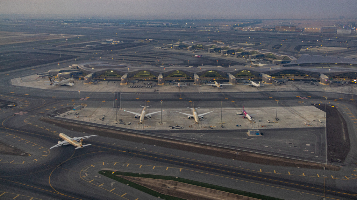Early morning dawn aerial panoramic view from an airplane window of the new passenger airport Terminal A with various aircraft parked or taxiing, the Zayed International Airport AUH also known as Abu Dhabi International Airport serving the capital of UAE which opened on November 2023. [Photo by Nicolas Economou/NurPhoto via Getty Images]