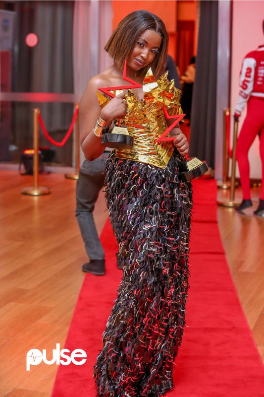 Claudia Naisabwa holds up her two Pulse Influencer Awards 2024 titles - Fashion Influencer of the Year and Best Dressed Influencer at the gala celebration on October 12, 2024