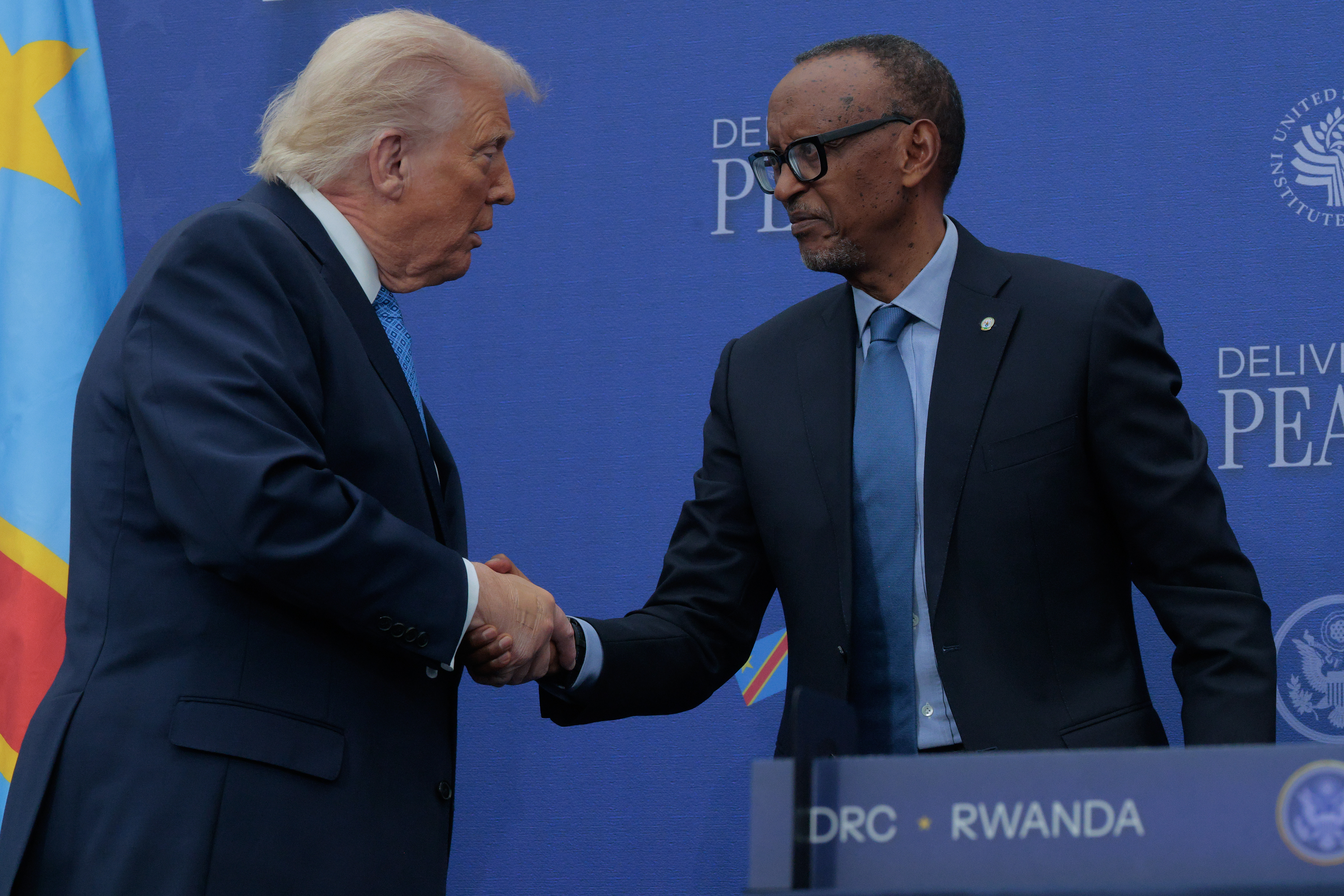 L-R: U.S. President Donald Trump shakes hands with Rwandan President Paul Kagame during a peace agreement signing ceremony between the Democratic Republic of Congo and Rwanda at the Donald J. Trump Institute of Peace on December 04, 2025, in Washington, DC. [Photo by Chip Somodevilla/Getty Images]