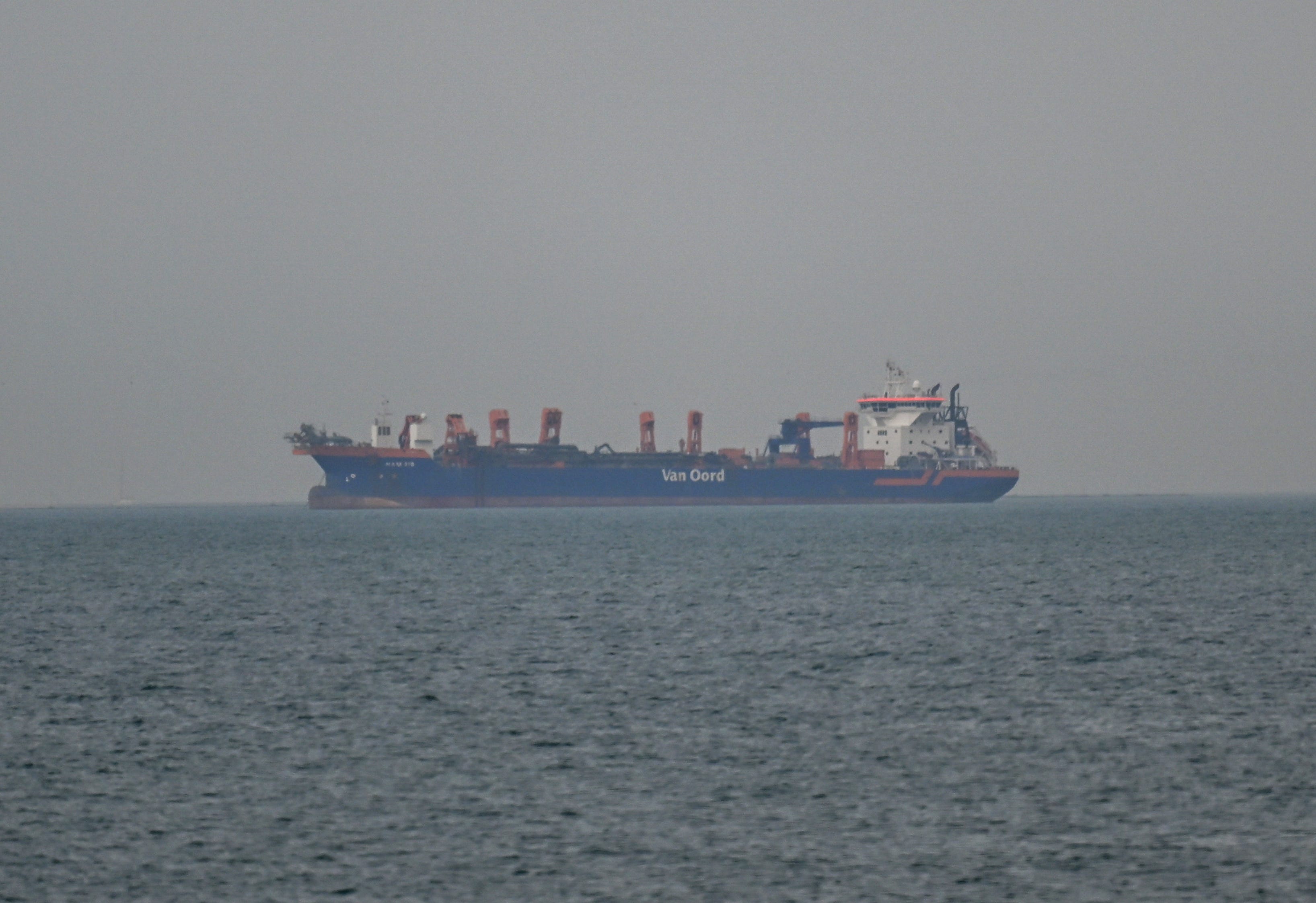 A commercial ship anchors off the coast of the United Arab Emirates amid disruptions in the Strait of Hormuz, a key shipping passage in the Middle East.Stringer/Anadolu via Getty Images
