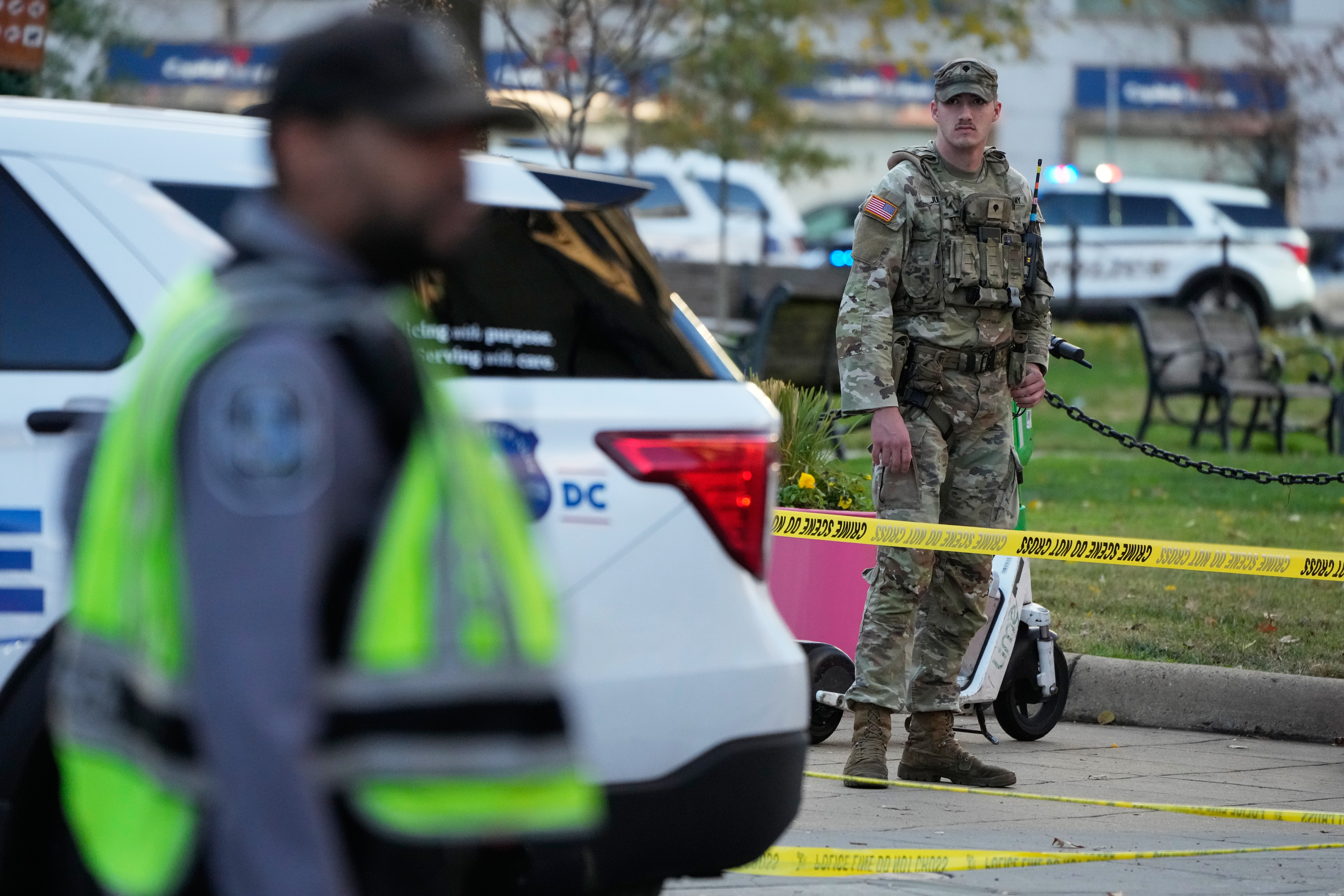 National Guard members and emergency personnel gather at a cordoned off area near the White House after a shooting on Nov. 26, 2025, in Washington.