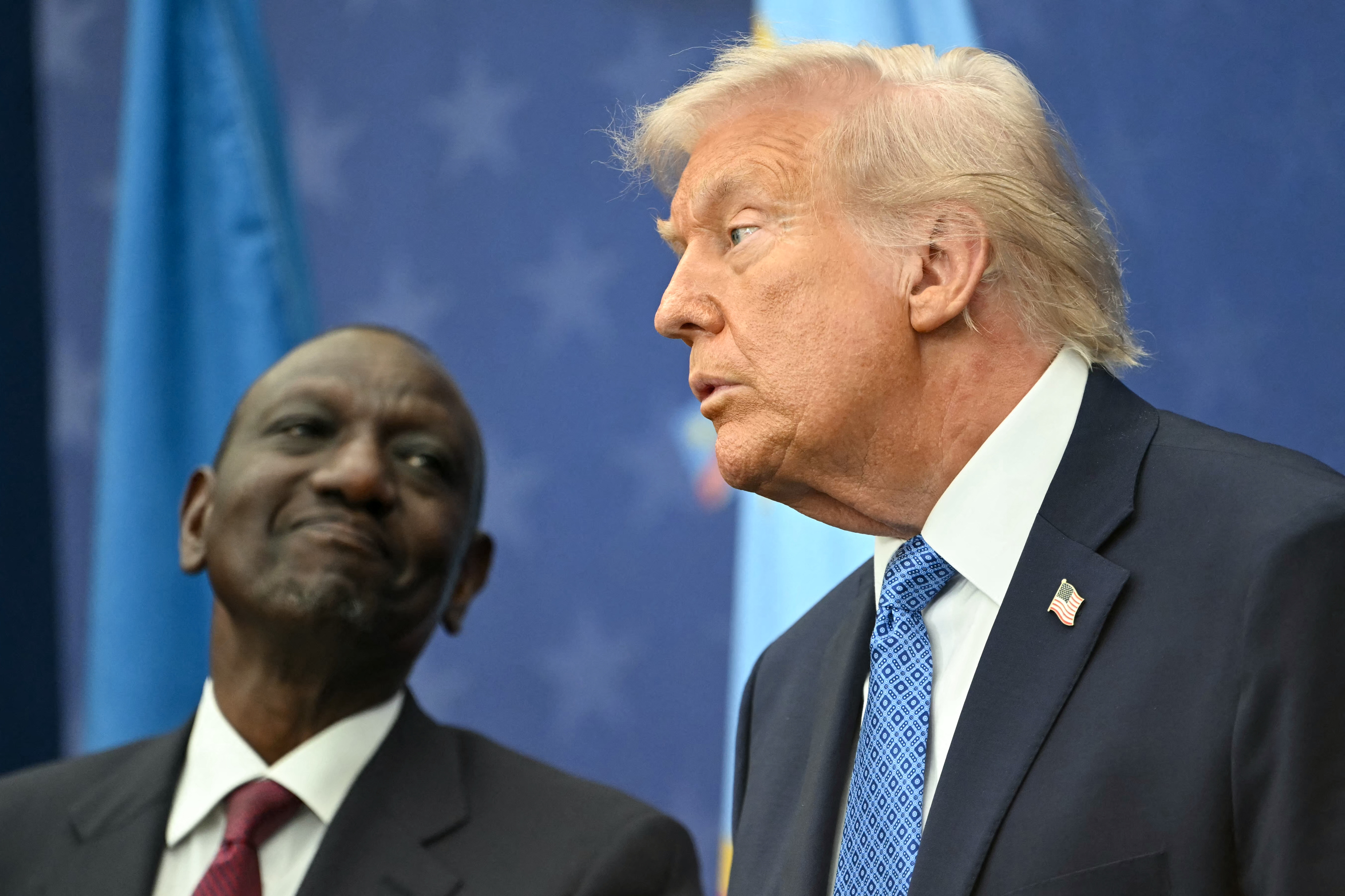 US President Donald Trump (R) and Kenya's President William Ruto attend the signing ceremony of a peace deal between Rwanda and the Democratic Republic of the Congo at the United States Institute of Peace in Washington, DC, on December 4, 2025. [Photo by ANDREW CABALLERO-REYNOLDS / AFP via Getty Images]