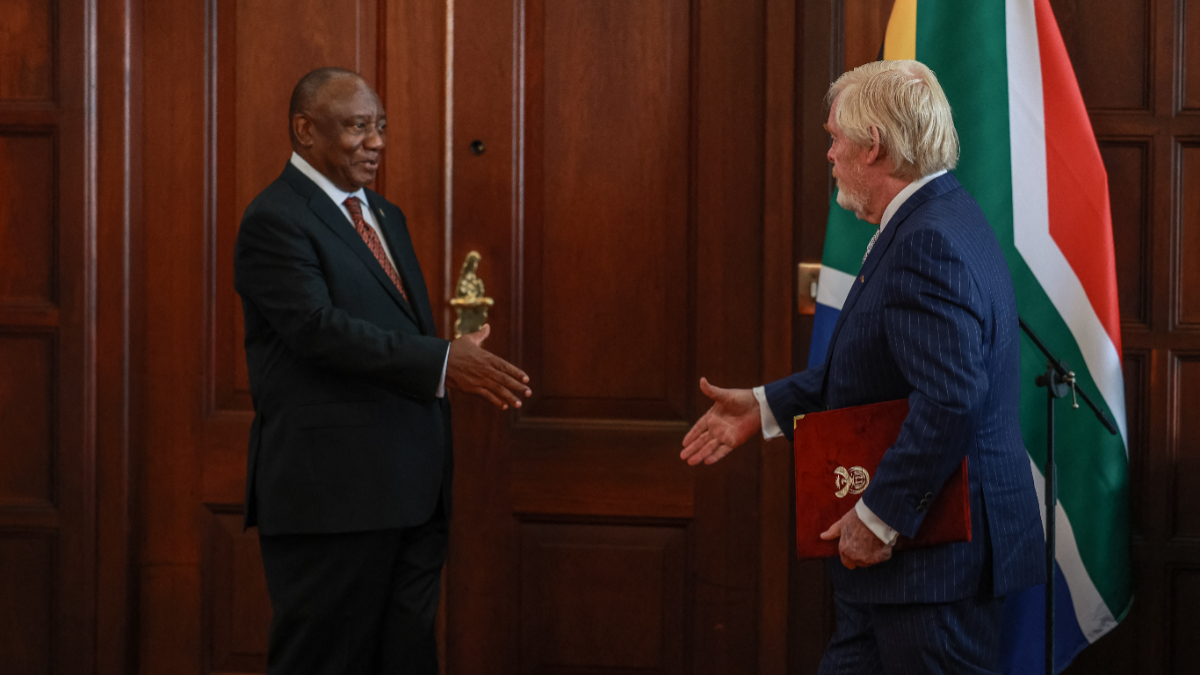 US Ambassador to South Africa Leo Brent Bozell III (R) presents his letters of credence to South African President Cyril Ramaphosa at Sefako Makgatho Presidential Guest House in Pretoria on April 8, 2026. [Photo by Phill Magakoe / AFP via Getty Images]