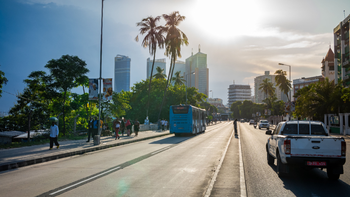 Traffic drives down Kivokoni Road towards tall buildings in the Ilala central business district in Dar es Salaam, Tanzania. [Photo by Andy Soloman/UCG/Universal Images Group via Getty Images]