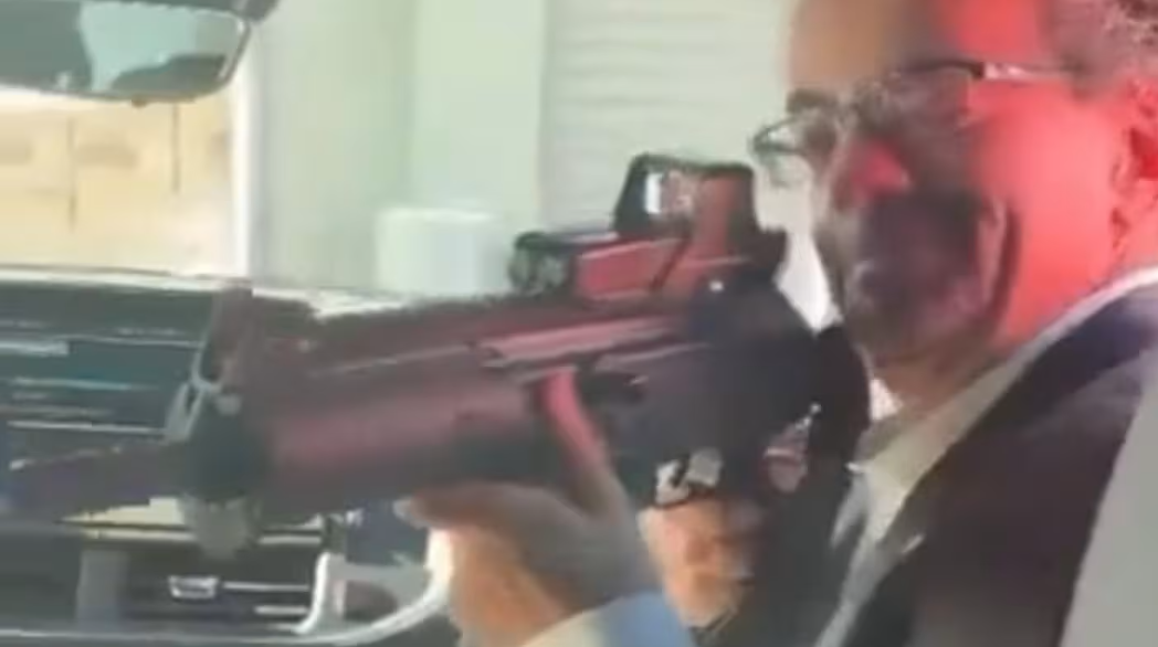 Jon Benjamin holding an assault rifle in a video that was posted on X © @subdiplomatic/X UK