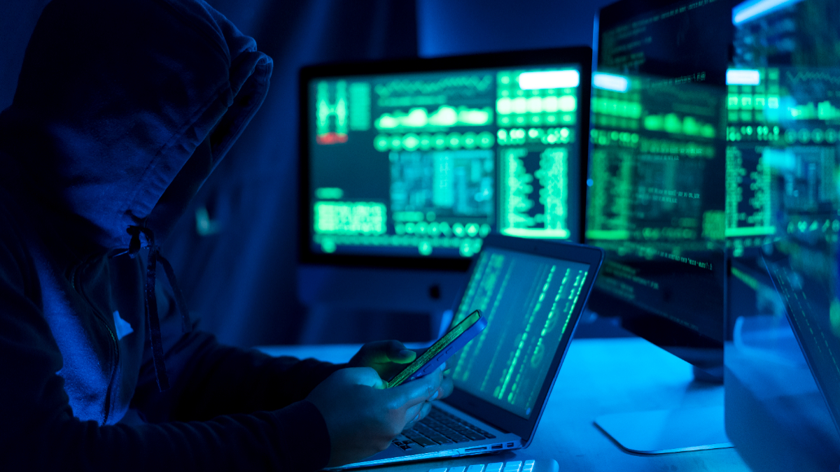 Hacker, IT and person with code on computer, programming and phishing scam with malware or virus. [ Seksan Mongkhonkhamsao/Getty Images]