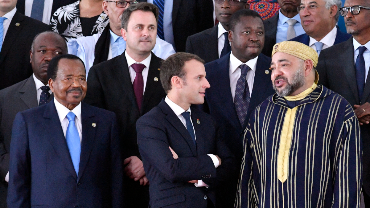 French President Emmanuel Macron (front row, C) speaks with King Mohammed VI of Morocco (front row, R) as leaders pose for a family photo during the 5th African Union - European Union (AU-EU) summit in Abidjan, on November 29, 2017. [Photo by ISSOUF SANOGO/AFP via Getty Images]