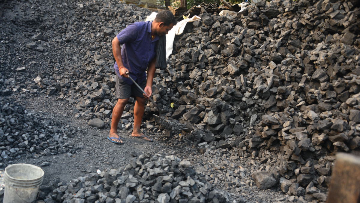 An Indian worker works in a coal depot in Siliguri, India, on April 3, 2025. [Photo by Diptendu Dutta/NurPhoto via Getty Images]