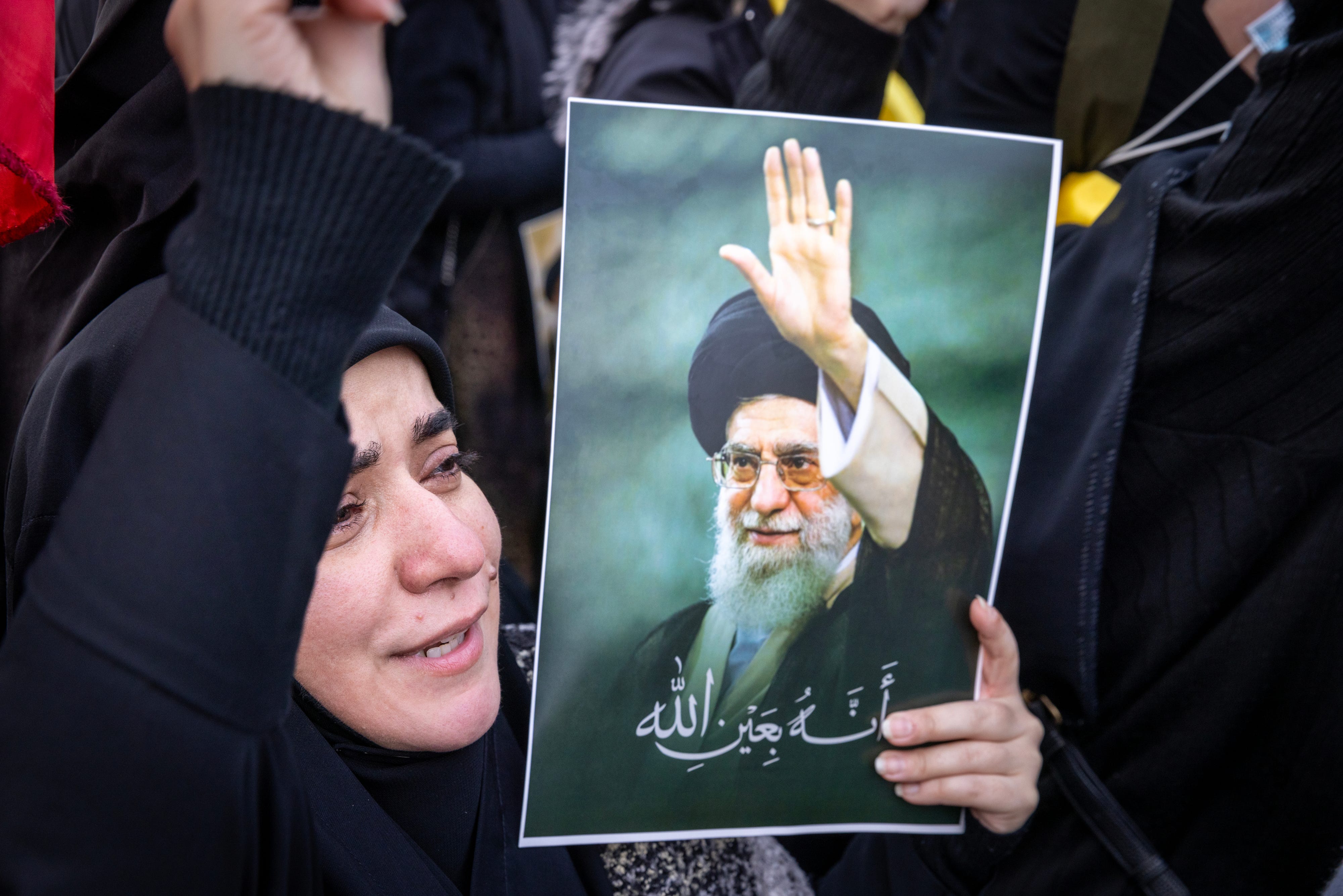 A woman in Beirut cries while holding a picture Iran's former Supreme Leader, Ayatollah Ali Khamenei.Daniel Carde/Getty Images