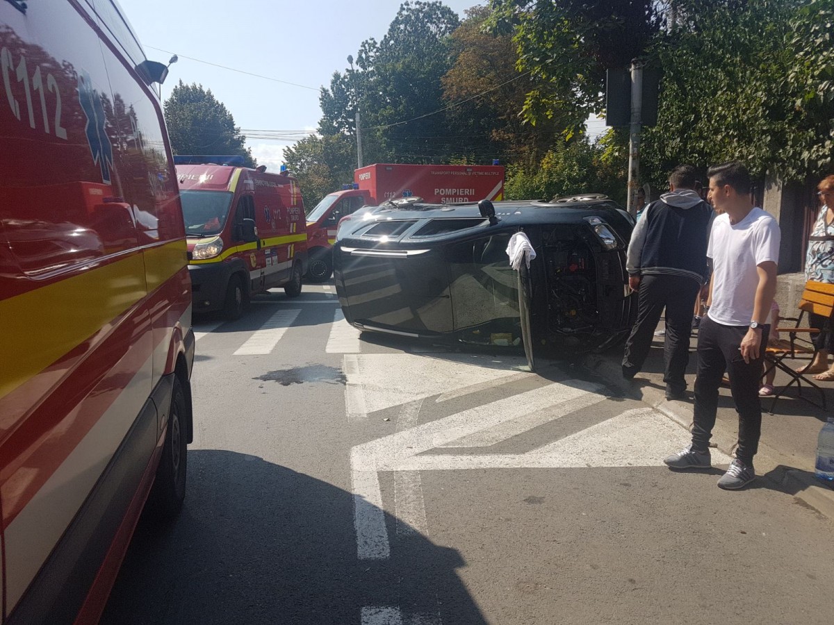 FOTO | Accident spectaculos în centrul Sibiului. Două mașini s-au tamponat, iar una s-a răsturnat. Doi copii, printre răniți