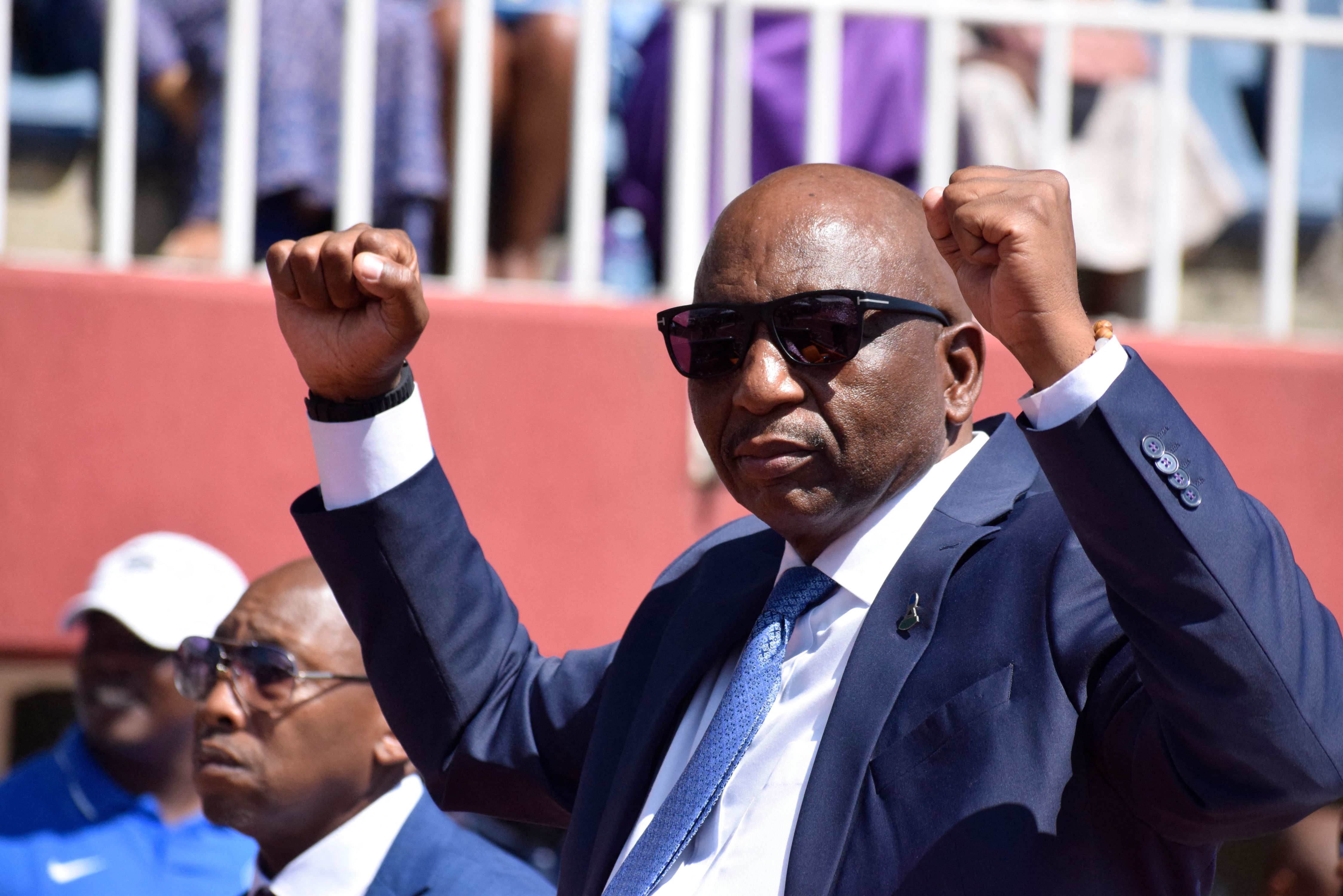 Lesotho Prime Minister Sam Ntsokoane Matekane raises his fists in celebrations as he arrives at his inauguration at Setsoto stadium in Maseru on October 28, 2022. [Photo by MOLISE MOLISE/AFP via Getty Images]