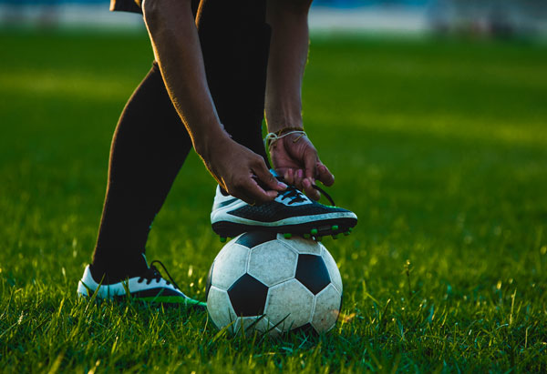 A person kicking a soccer ball