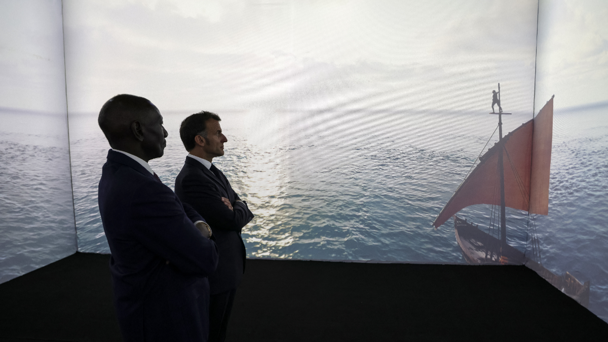 France's President Emmanuel Macron (R) and Kenya's President William Ruto (L) look at an Artificial Intelligence (AI) film made by film-makers from the Creation Africa program during the Africa Forward summit in Nairobi on May 11, 2026. [Photo by Ludovic MARIN / AFP via Getty Images]