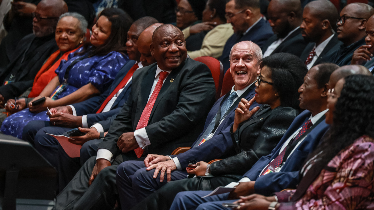 South African President Cyril Ramaphosa (CL) and Former Minister and constitutional negotiator Roelf Meyer (CR) looks at attendees during the first National Convention at the University of South Africa (UNISA) in Pretoria on August 15, 2025. [Photo by Phill Magakoe/AFP via Getty Images]