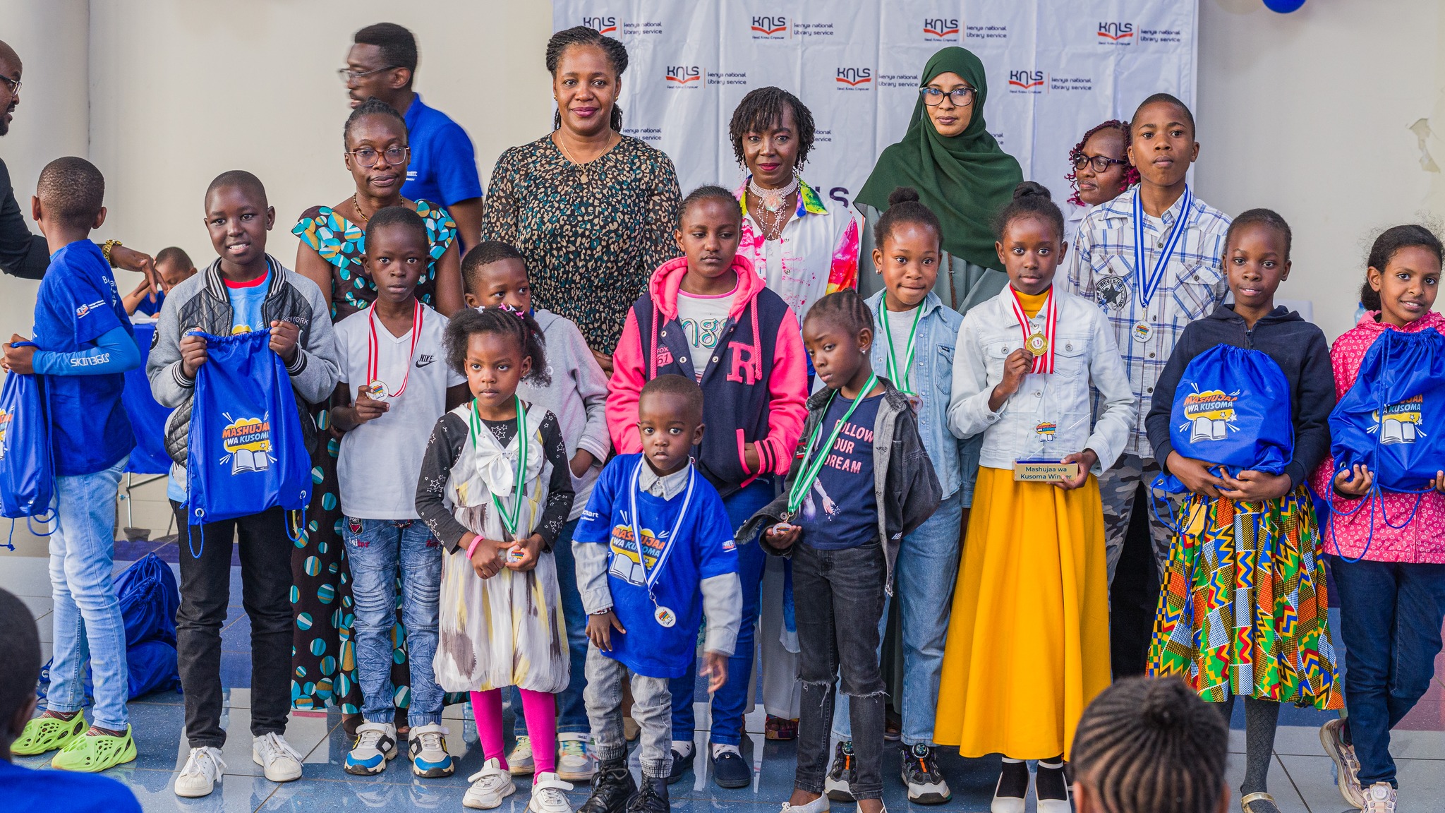 Kids and officials pose for a photo during during the World Readers Awards at Kenya National Library.