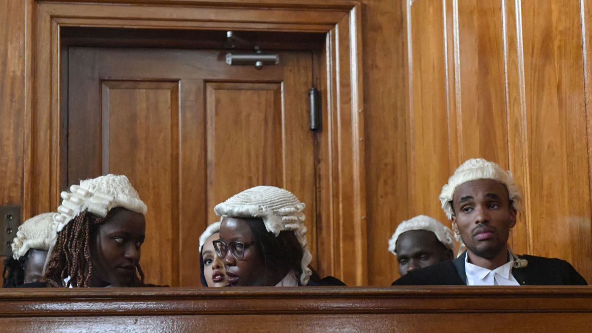 Some newly admitted advocates, wait inside the Supreme Courtroom to pick-up their 'certificates of practise' at the Supreme Courts of Kenya in the capital Nairobi on September 2, 2019. [Photo by SIMON MAINA / AFP]