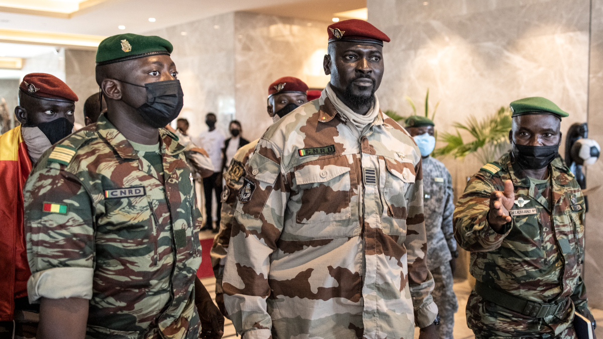 President of the National Committee for Rally and Development (CNRD) Colonel Mamady Doumbouya (C) leaves a meeting with high level representatives of the Economic Community of West African States (ECOWAS) in Conakry on September 17, 2021. [Photo by JOHN WESSELS/AFP via Getty Images]