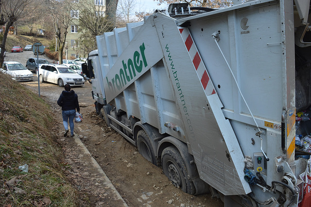 O stradă s-a surpat în Reșița. Două mașini de gunoi, „înghițite” de șosea