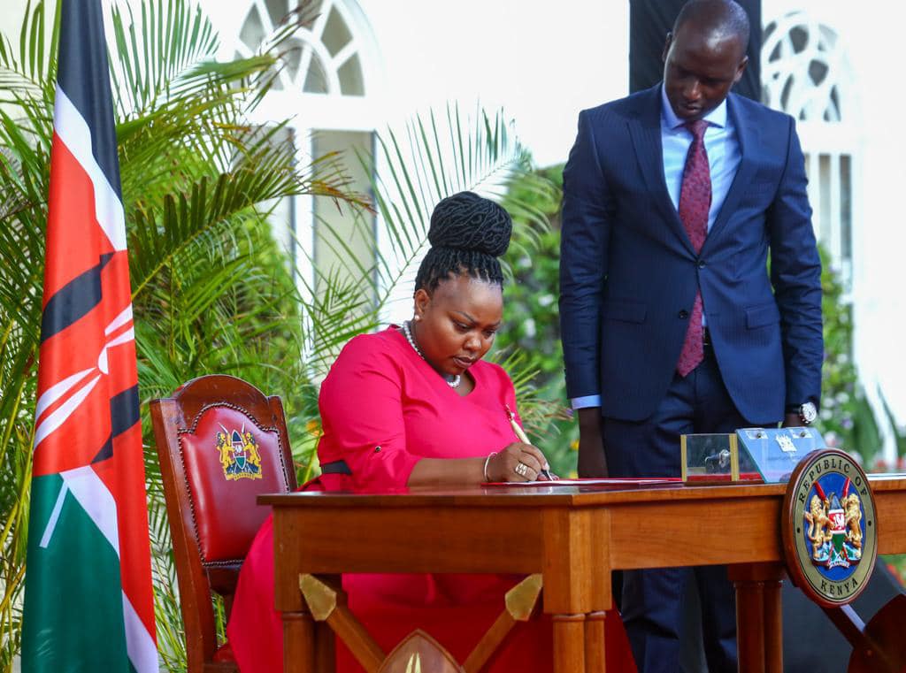 Millicent Omanga signs her oath of office at State House on March 23, 2023 after she was nominated to serve as CAS in the Ministry of Interior. A High Court ruling later saw the position scrapped off from President William Ruto's government