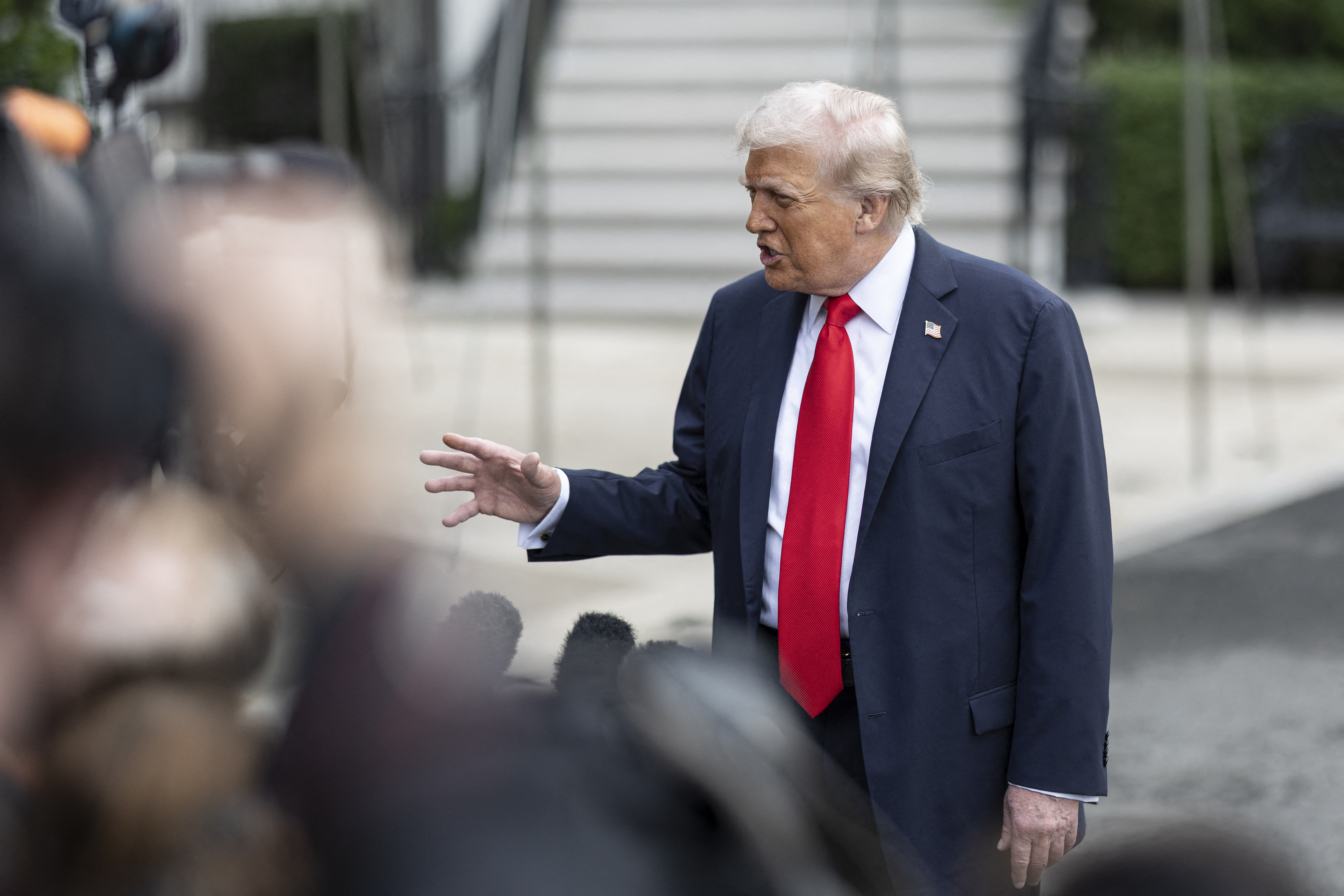 President Donald Trump speaks to members of the press as he departs the White House en route to the United Kingdom on September 16, 2025 in Washington.