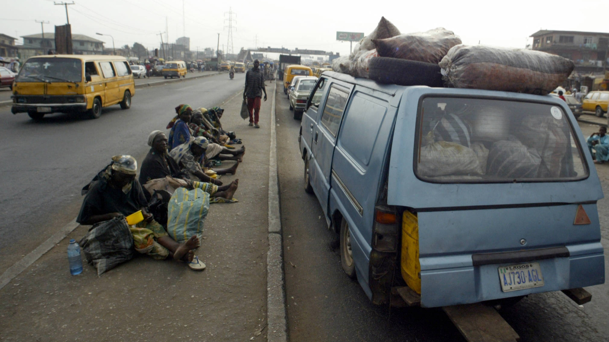 Beggars sit on Lagos Ikorodu highway 06 February 2006. Lagos is reputed as one of the mostly densely populated city in the world with population more than 14 million. [Getty Images]