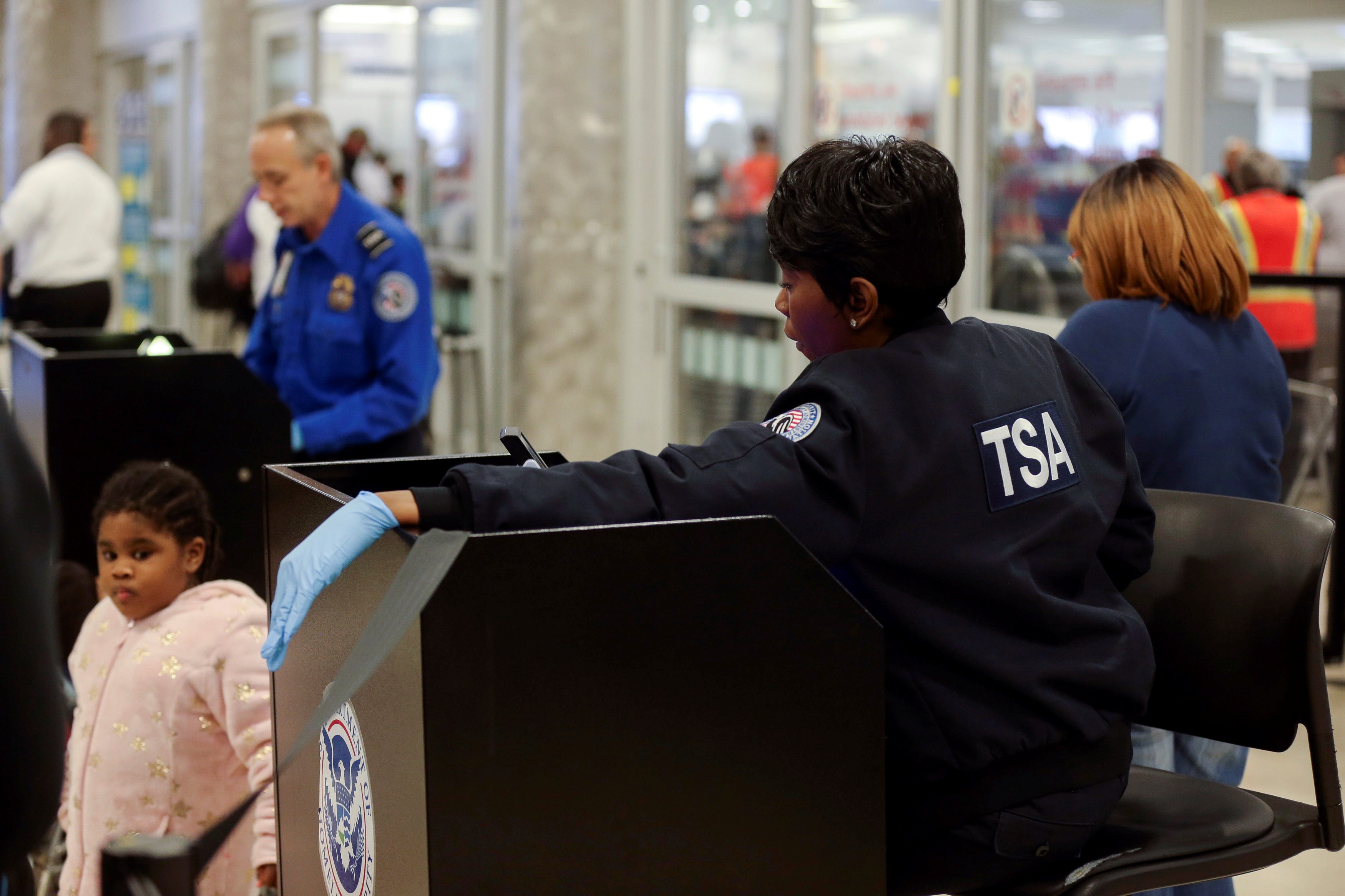 TSA agents screen passengers at a security checkpoint at Hartsfield-Jackson Atlanta International Airport amid the partial federal government shutdown, in AtlantaReuters