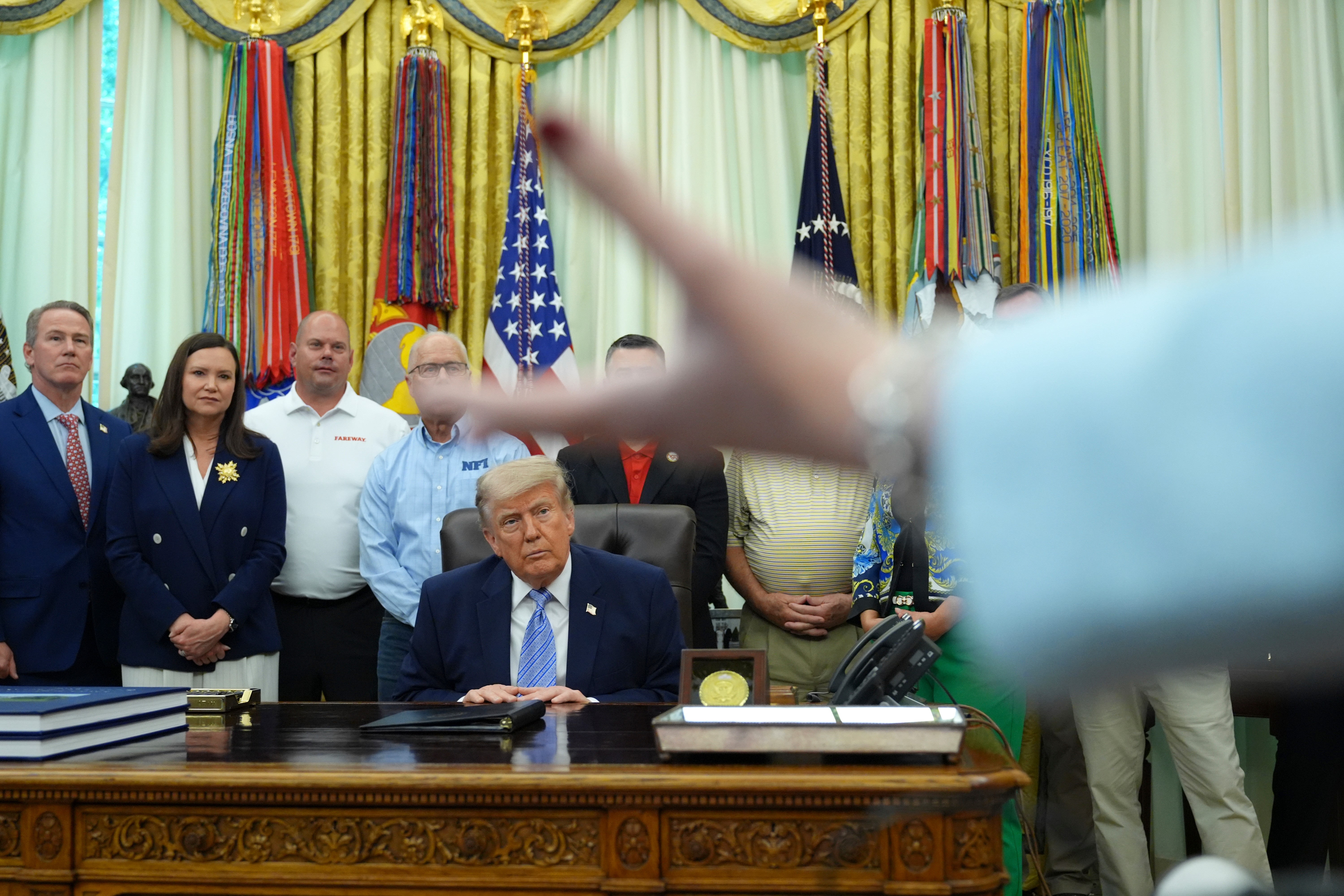 President Donald Trump speaks to reporters at the White House on Thursday.
