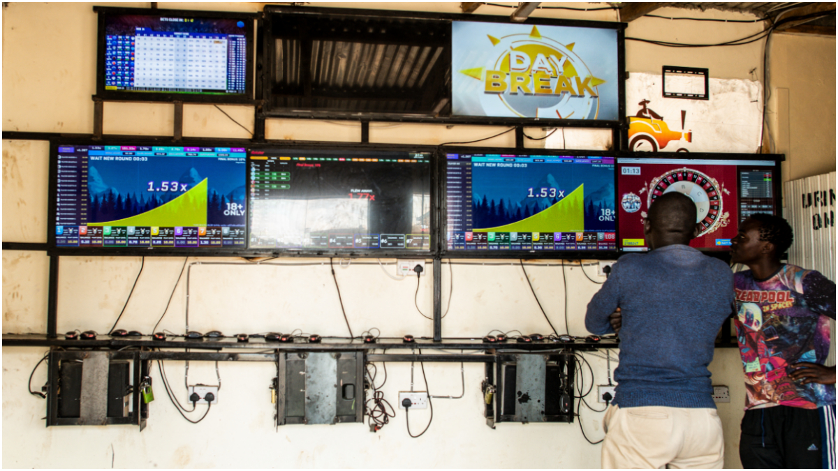 Men gather in front of screens at an online gambling hall at the Kibera informal settlement in Nairobi, on May 18, 2025. [Photo by GORDWIN ODHIAMBO/AFP via Getty Images]
