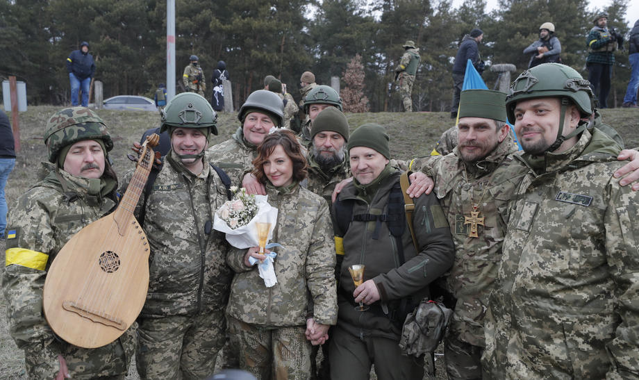 Nuntă pe front. În haine de camuflaj, cu alai înarmat cu flori și puști, doi militari ucraineni s-au căsătorit