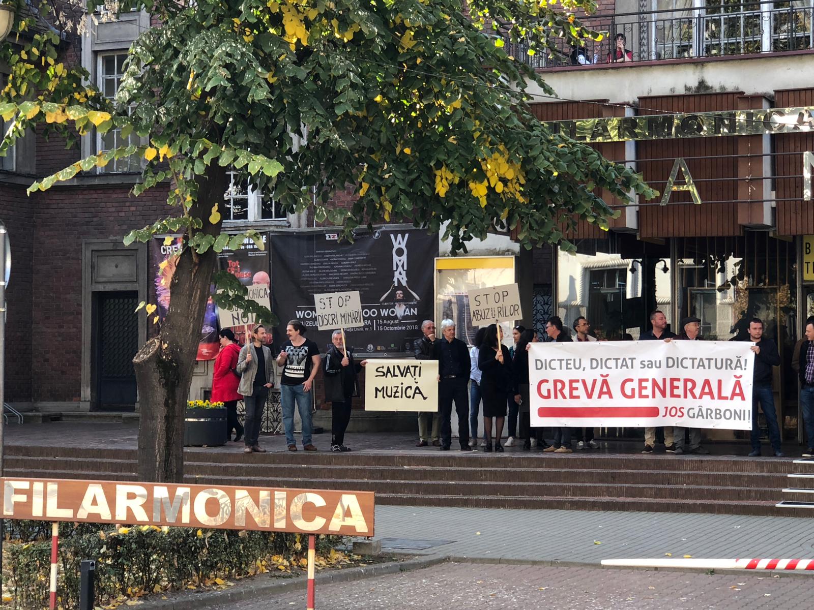 FOTO/ În conflict de doi ani, artiștii Filarmonicii Banatul din Timișoara au ieșit cu instrumentele în stradă: “Arta suferă că s-a ajuns la așa ceva”