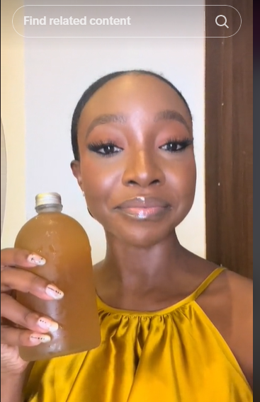 Ini Dima-Okojie with the herbal drink [TikTok/@indimaokojie]
