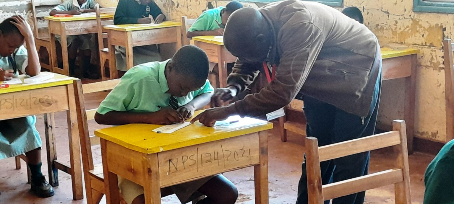 An examination invigilator is assisting a KPSEA candidate