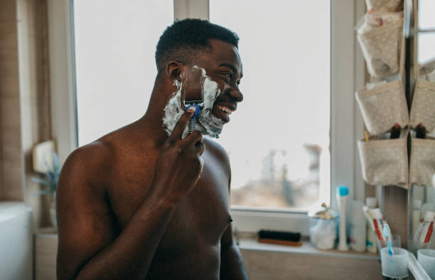 Photo of a man shaving his beard