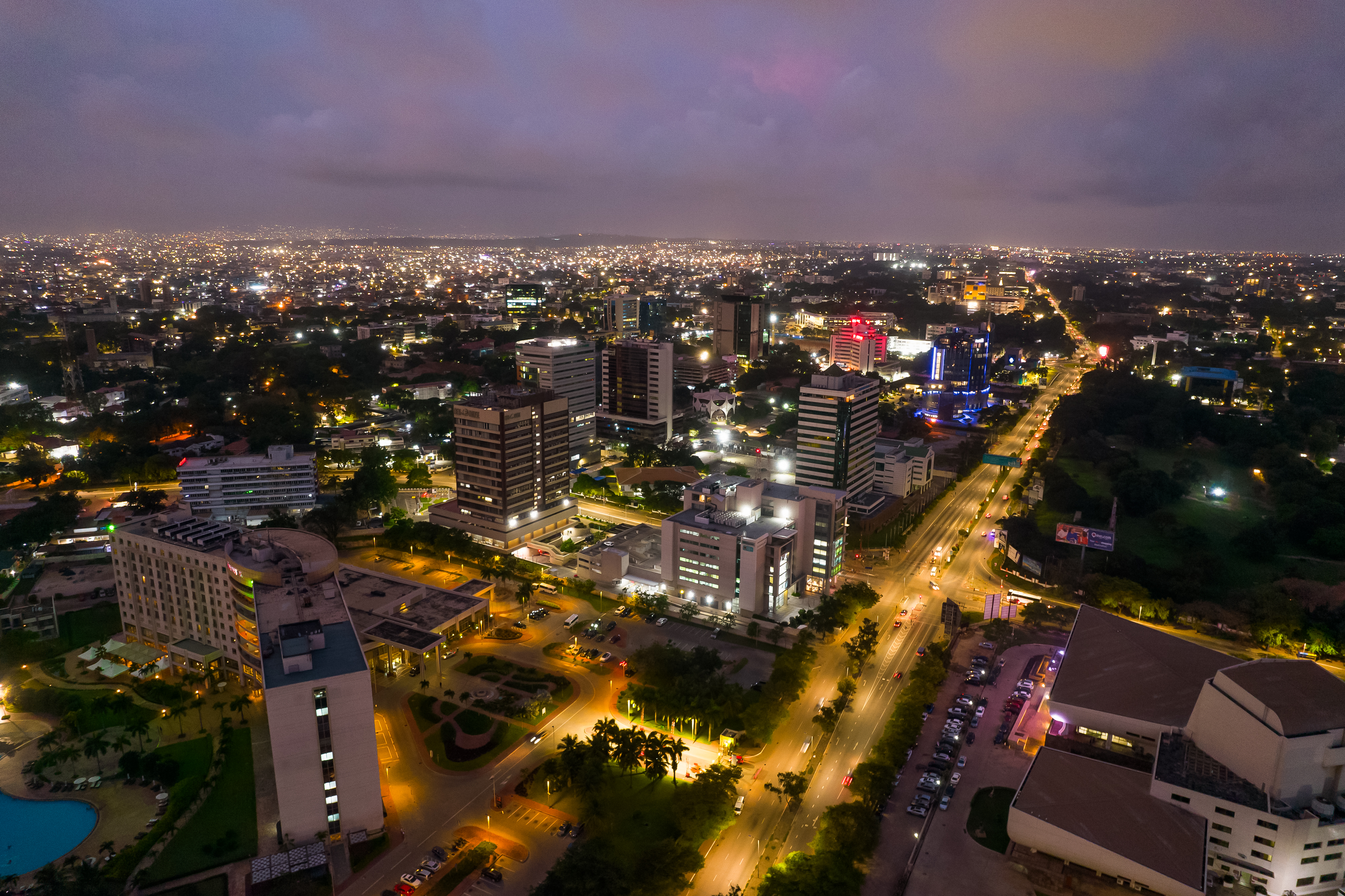 Accra, Ghana at night, aerial view of city lights and urban landscape under a twilight sky. [Stock Photo/Getty Images]