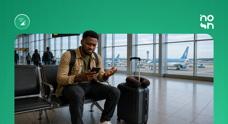 A traveler uses a smartphone at an airport terminal, highlighting the growing importance of seamless digital payments and instant mobile connectivity for international travel.