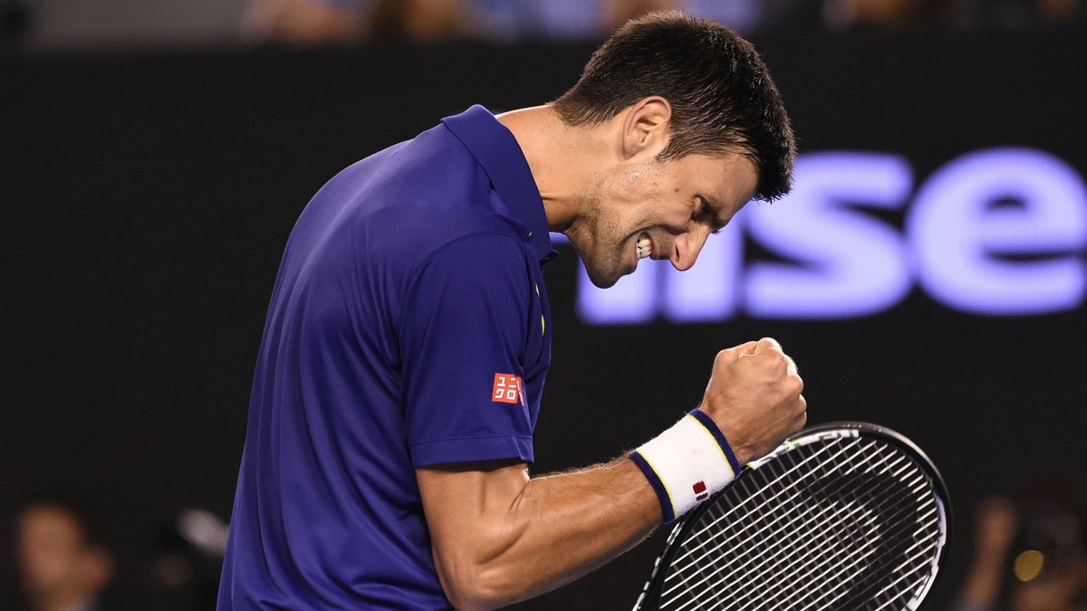 Serbia's Novak Djokovic celebrates winning a game during his men's singles final match against Britain's Andy Murray on day fourteen of the 2016 Australian Open tennis tournament in Melbourne on January 31, 2016. AFP PHOTO / WILLIAM WEST-- IMAGE RESTRICTE