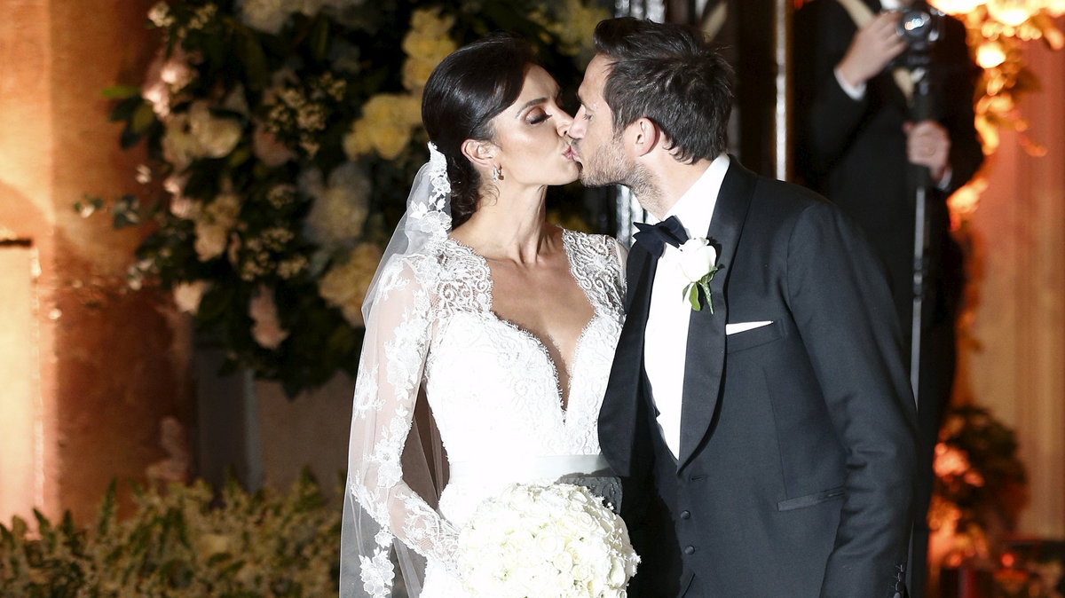 British TV personality Christine Bleakley and former Chelsea and England soccer player Frank Lampard kiss as they leave church after they married in London