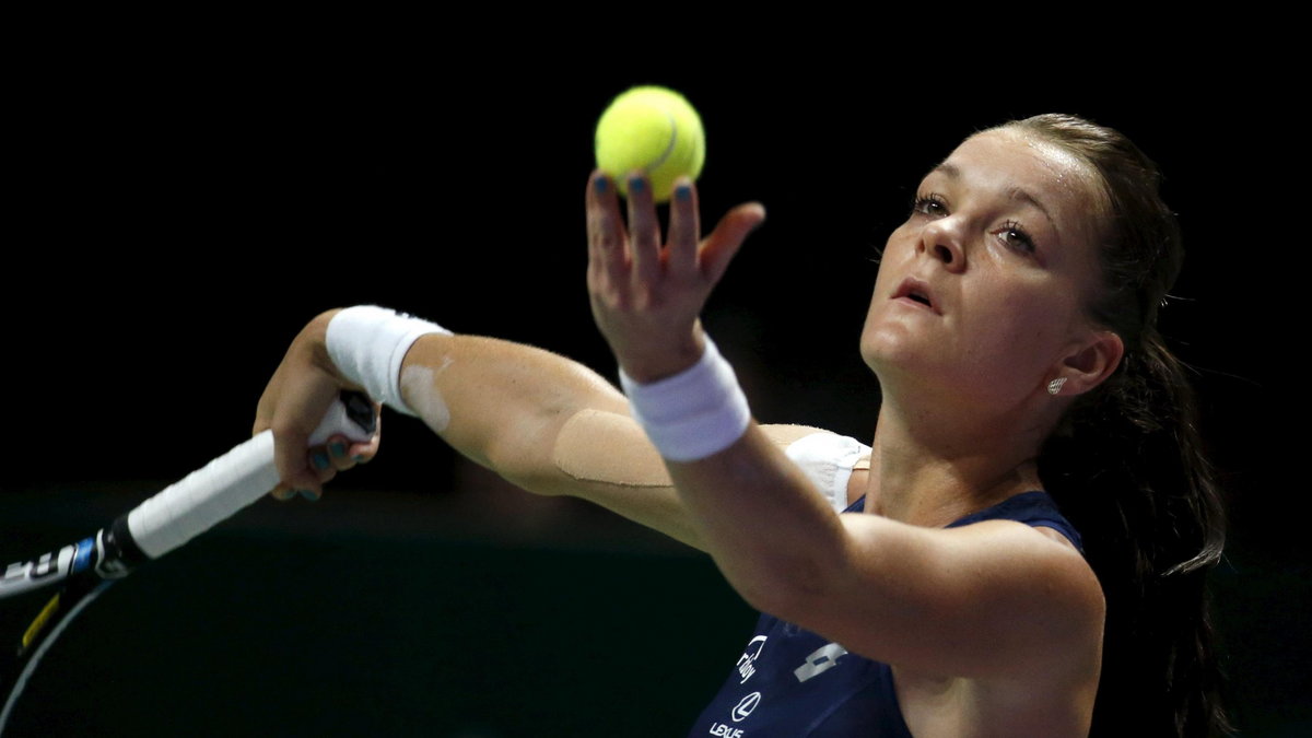 Agnieszka Radwanska of Poland serves to Flavia Pennetta of Italy during their women's singles tennis match of the WTA Finals at the Singapore Indoor Stadium