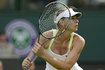 Maria Sharapova of Russia prepares to hit a return to Anastasia Rodionova of Australia during their women's singles tennis match at the Wimbledon tennis championships in London