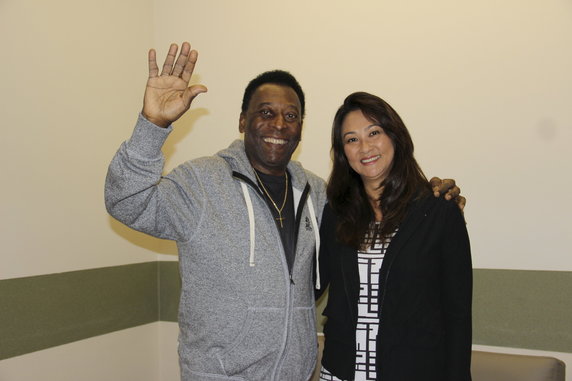 Brazilian soccer legend Pele waves with his wife Marcia Cibele Aoki at the Albert Einstein Hospital in Sao Paulo