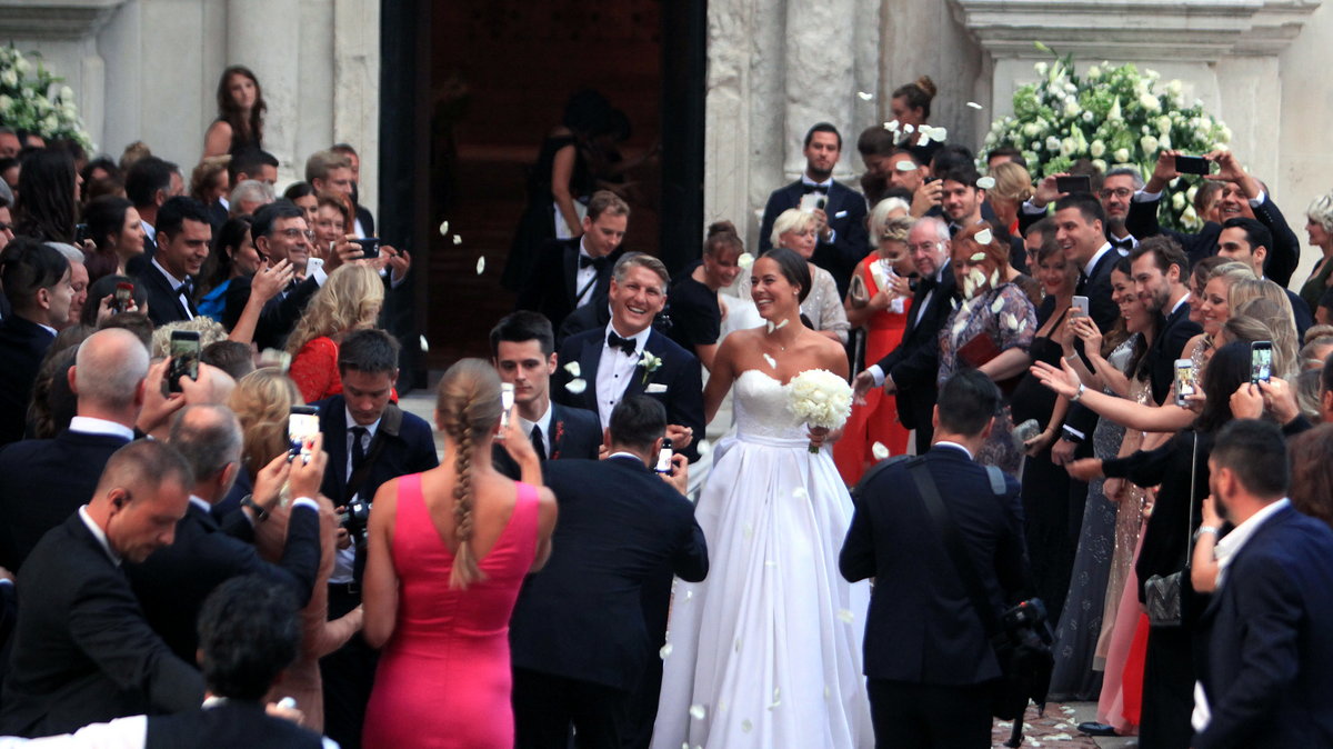 German football player Schweinsteiger and Serbian tennis player Ivanovic exit the church after the wedding ceremony in Venice