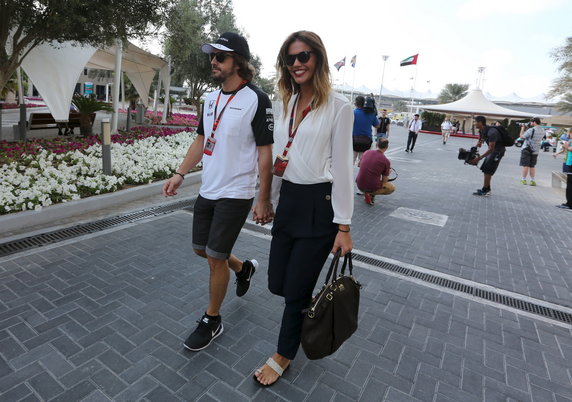 McLaren Formula One driver Fernando Alonso of Spain and girlfriend Lara Alvarez arrive ahead of the third free practice session of Abu Dhabi F1 Grand Prix at the Yas Marina circuit in Abu Dhabi