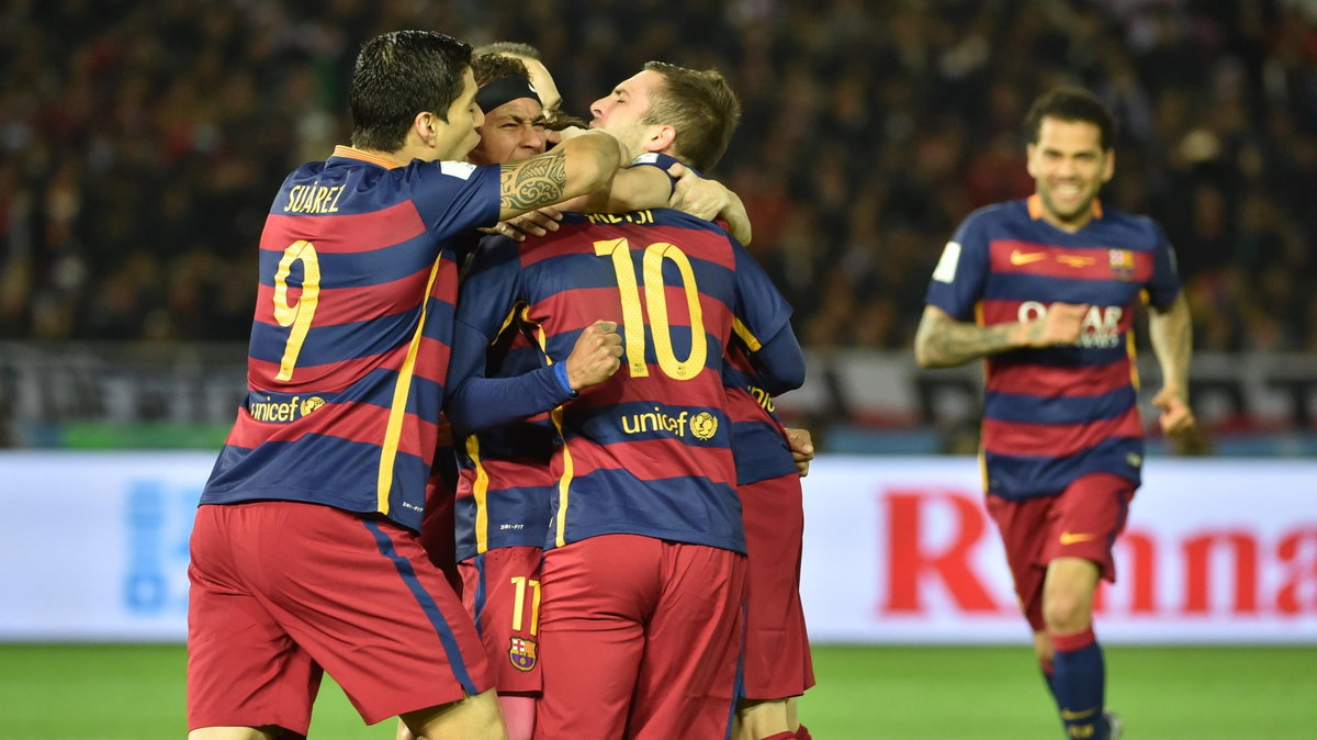 Barcelona forward Lionel Messi (#10) celebrates with teammates after his goal against River Plate during the Club World Cup football final in Yokohama on December 20, 2015. AFP PHOTO / KAZUHIRO NOGI / AFP / KAZUHIRO NOGI