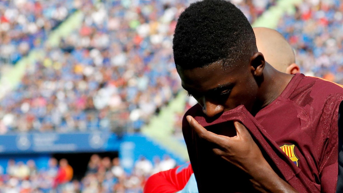 Barcelona's record signing Dembele reacts as he leaves the pitch after sustaining an injured during his Spanish La Liga match against Getafe