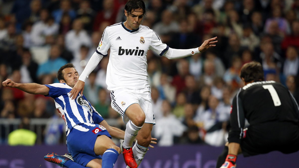 Real Madrid's Kaka is challenged by Deportivo Coruna's Carlos Marchena and goalkeeper Daniel Aranzubia during their Spanish first division soccer match at Santiago Bernabeu stadium in Madrid