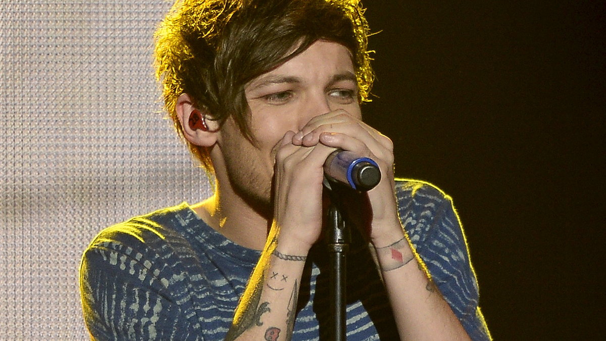 Louis Tomlinson of the band "One Direction" performs during the KIIS FM's iHeartRadio Jingle Ball 2015 concert at Staples Center in Los Angeles