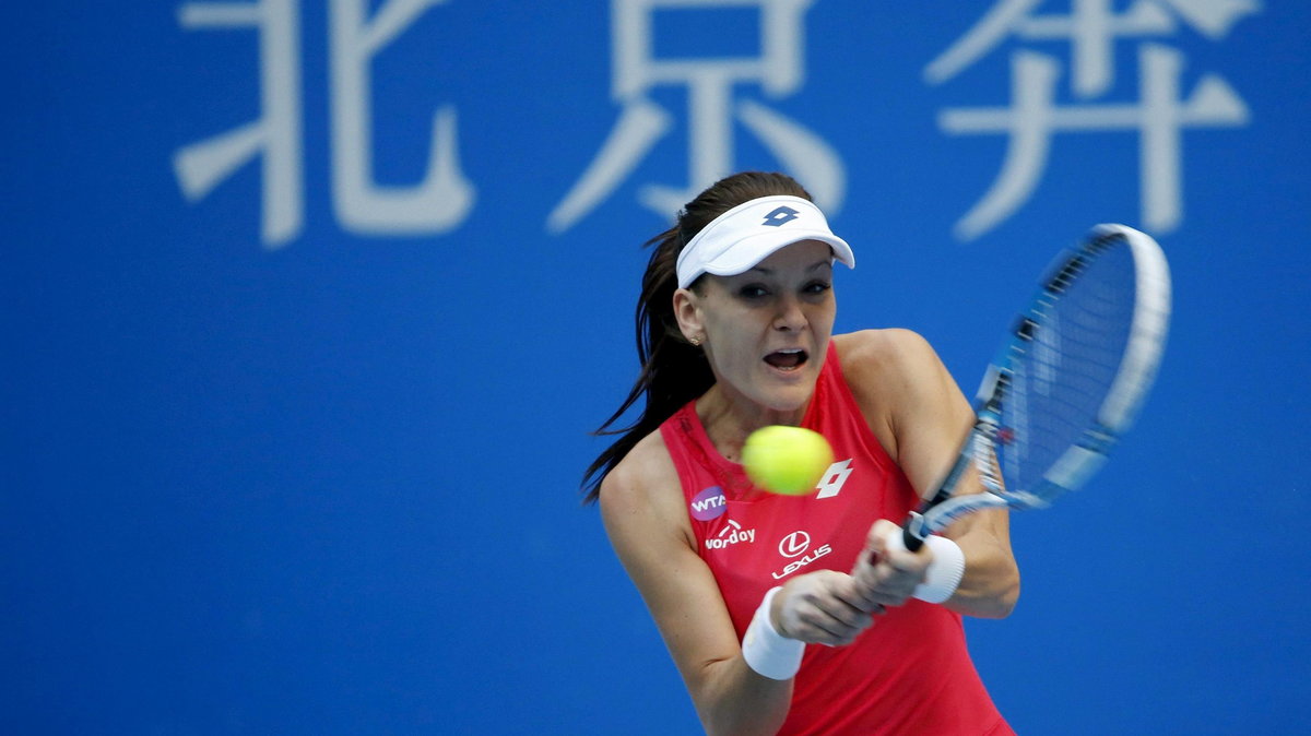 Agnieszka Radwanska of Poland hits a return against Angelique Kerber of Germany during their women's singles match at the China Open tennis tournament in Beijing